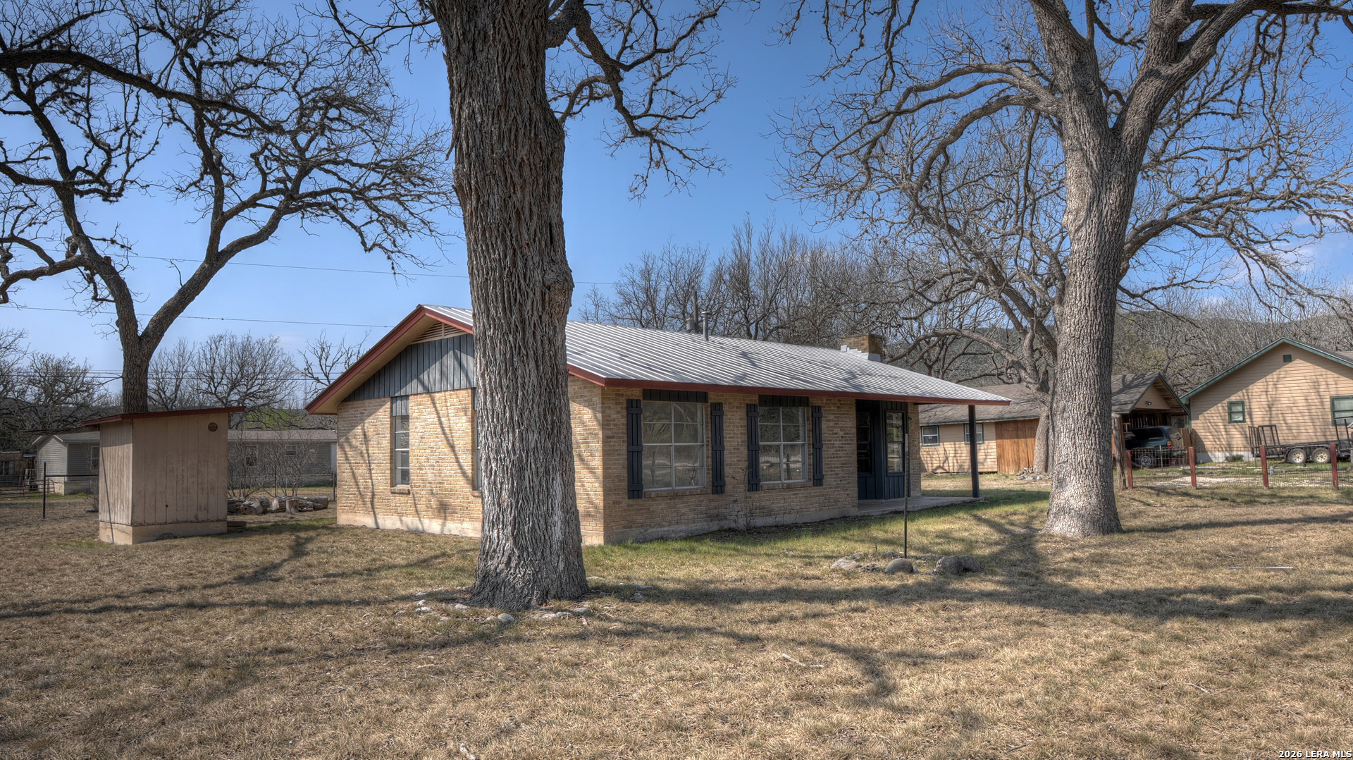 311 Patterson Creek Road Leakey, TX 78873 - Photo 16 of 16 a view of a house with a yard