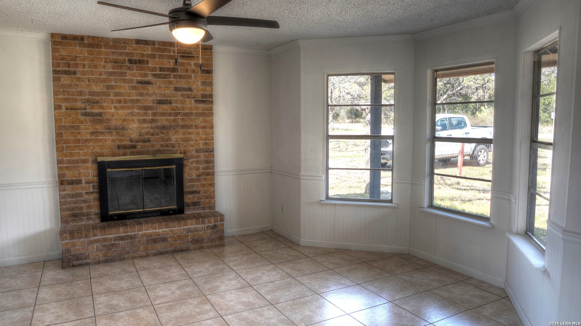 311 Patterson Creek Road Leakey, TX 78873 - Photo 2 of 16 an empty room with windows and fireplace