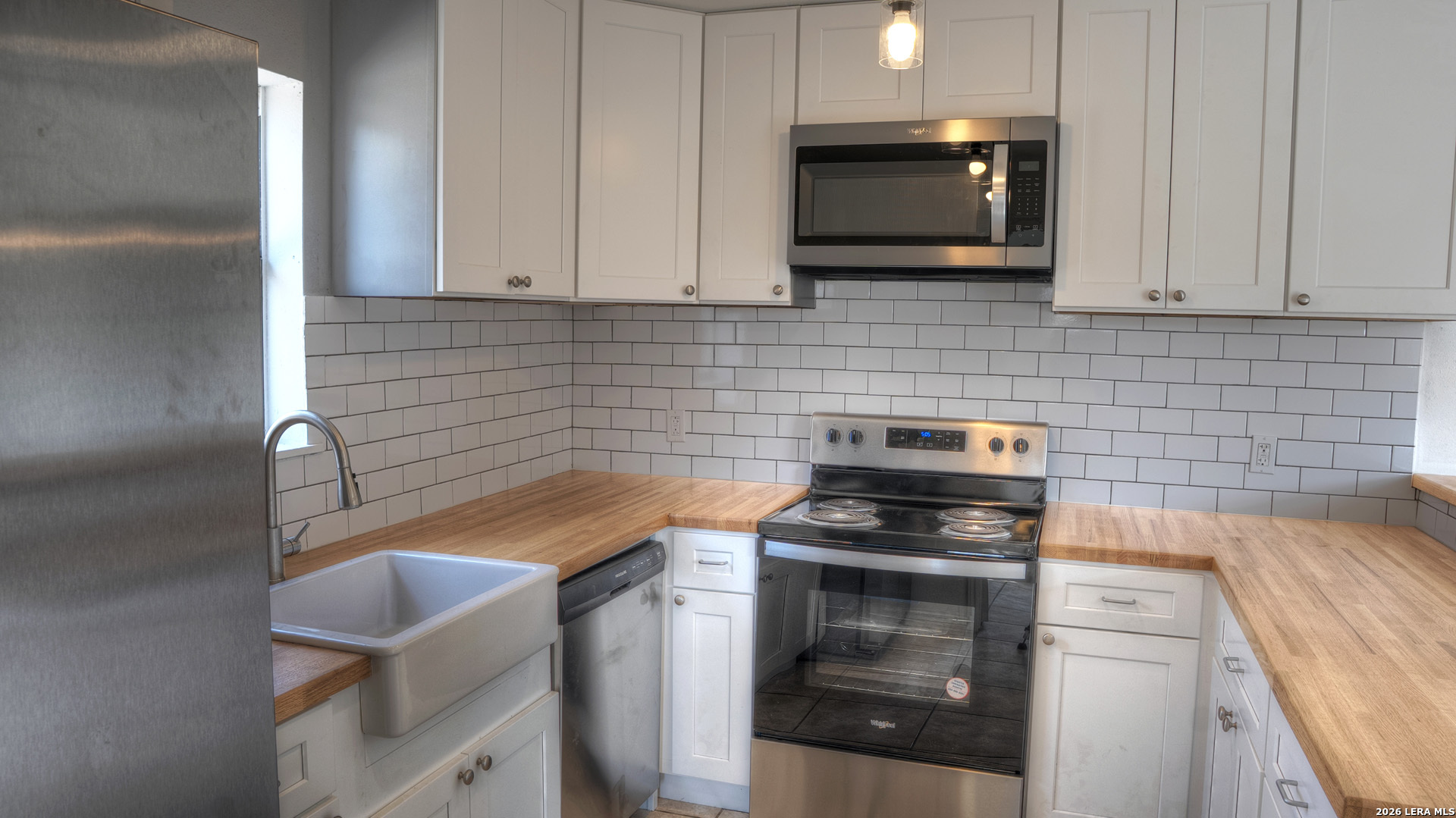 311 Patterson Creek Road Leakey, TX 78873 - Photo 4 of 16 a kitchen with a stove and a microwave