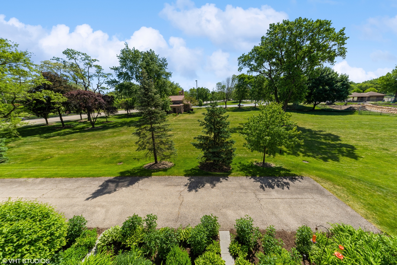620 McHenry Road, Unit 205 Wheeling, IL 60090 - Photo 27 of 28 a view of a garden with a building in the background