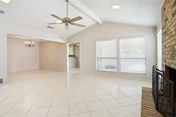 a view of a livingroom with a ceiling fan and window