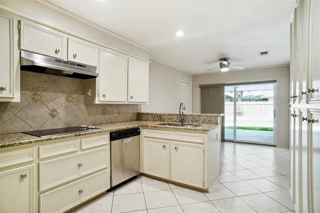 a kitchen with granite countertop white cabinets and white appliances