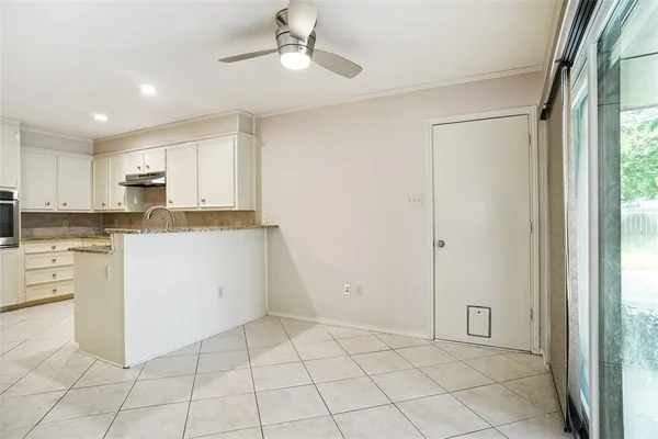a kitchen with white cabinets and white appliances