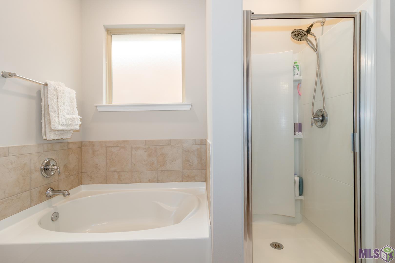 6407 Tiger Pointe Dr. St. George, LA 70817 - Photo 11 of 23 View of primary bath showing soaking tub and separate shower