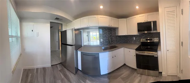 a kitchen with stainless steel appliances a microwave a stove and a refrigerator