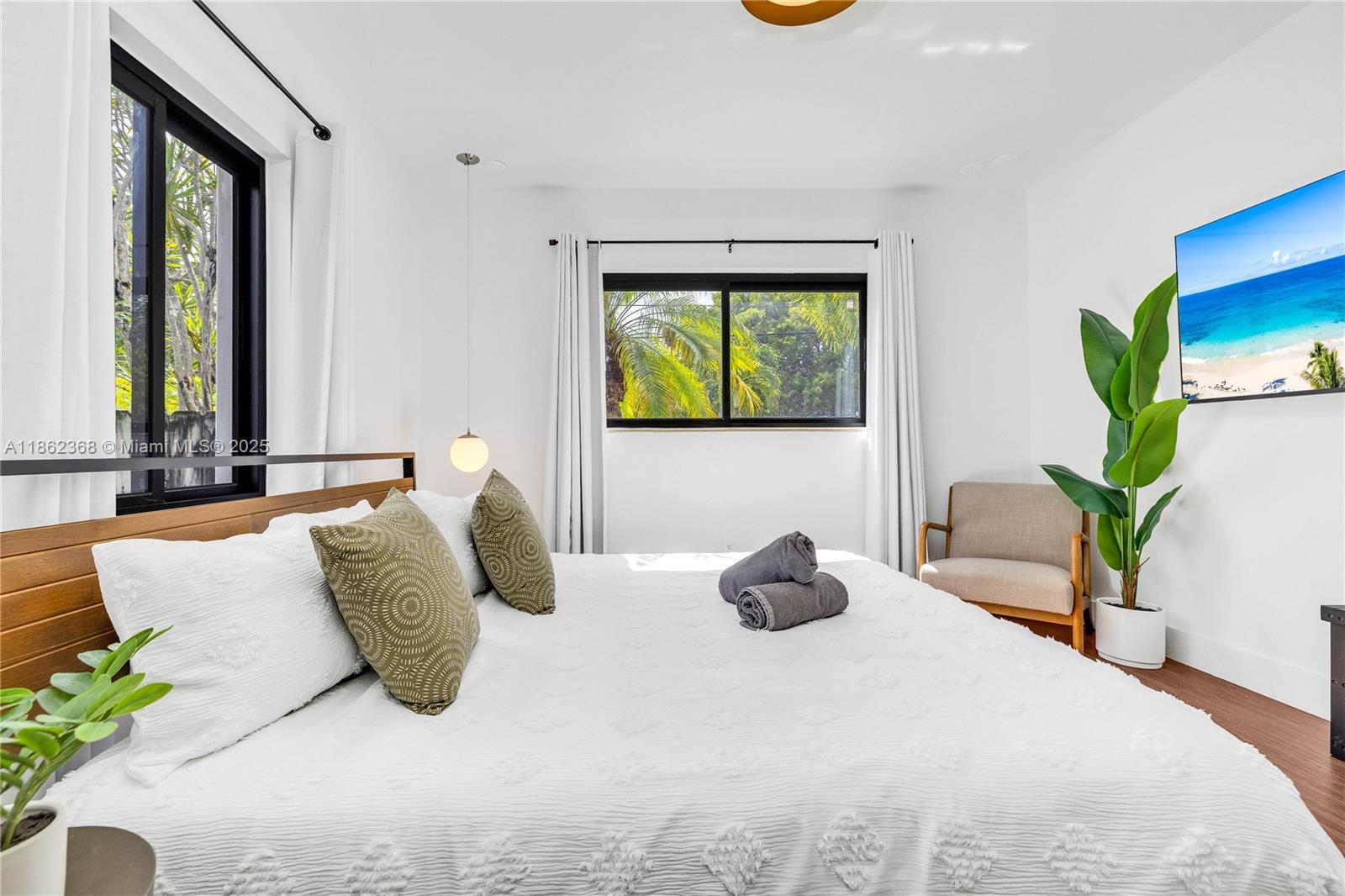 341 Southwest 21st Road Miami, FL 33129 - Photo 16 of 36 a bedroom with a bed and a potted plant