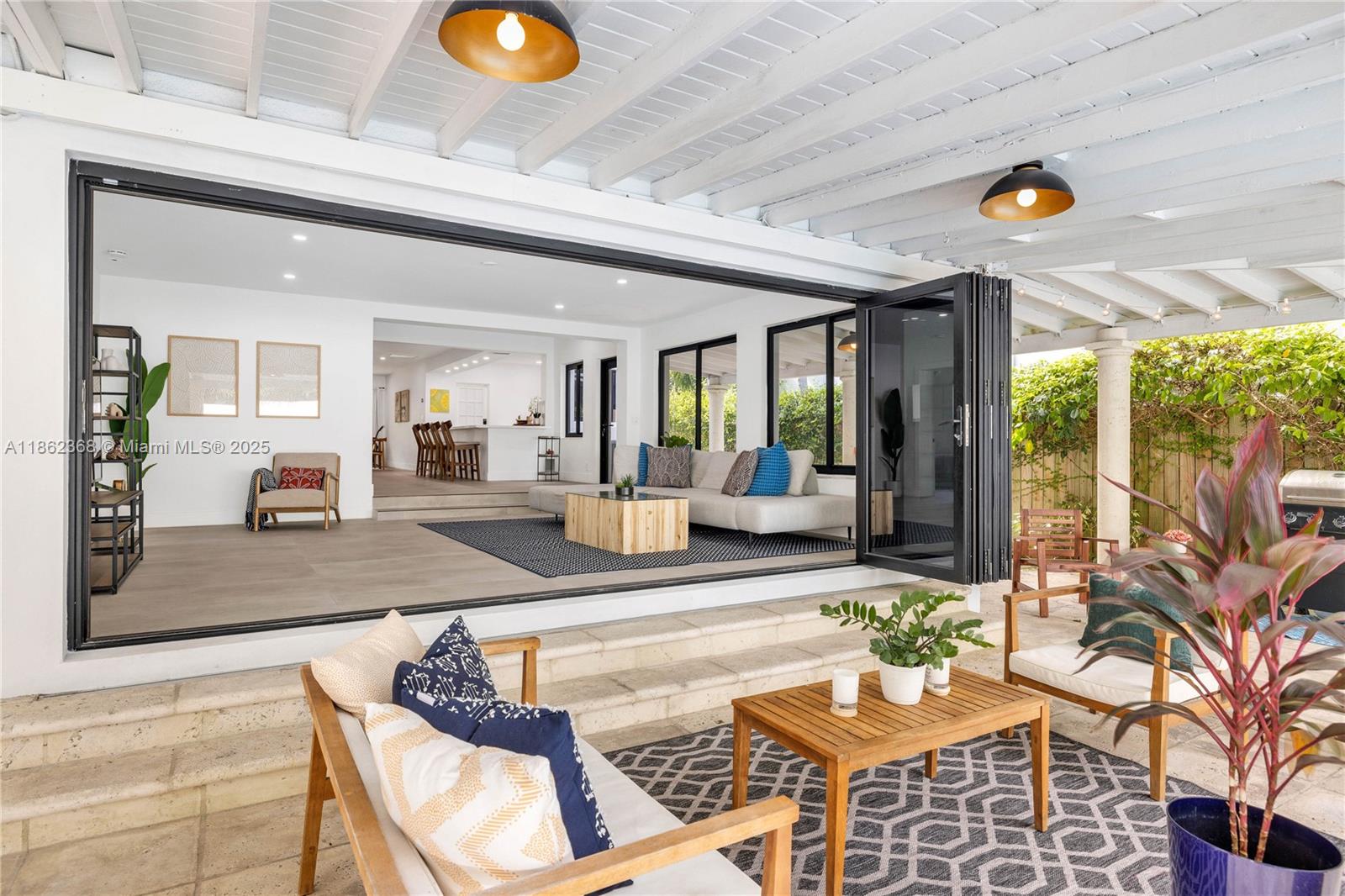 341 Southwest 21st Road Miami, FL 33129 - Photo 5 of 36 a living room with patio furniture and a potted plant