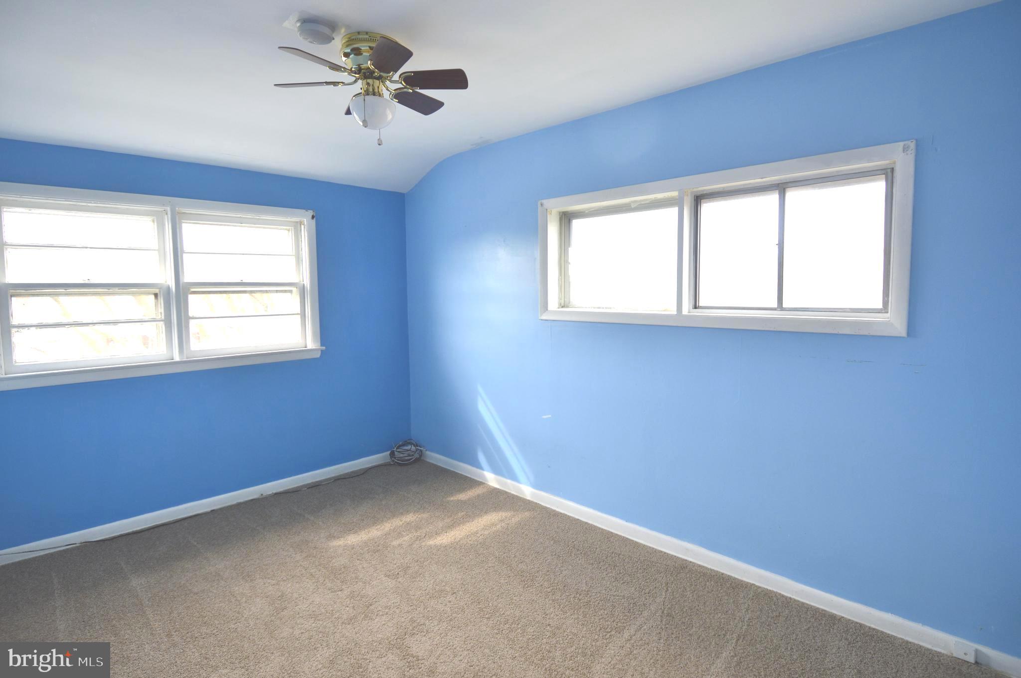 9742 Conmar Road Baltimore, MD 21220 - Photo 14 of 22 an empty room with windows and fan