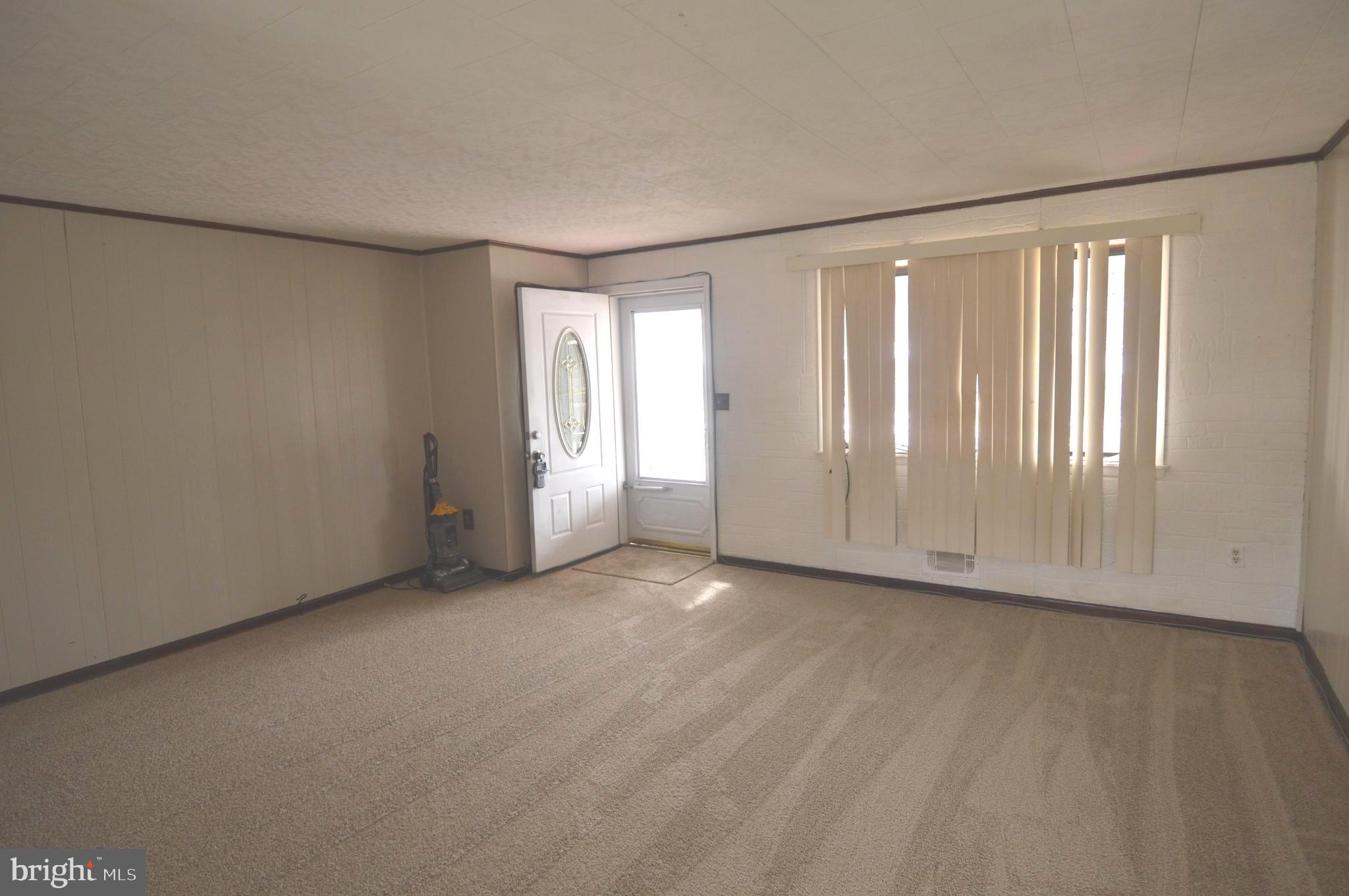 9742 Conmar Road Baltimore, MD 21220 - Photo 5 of 22 an empty room with windows