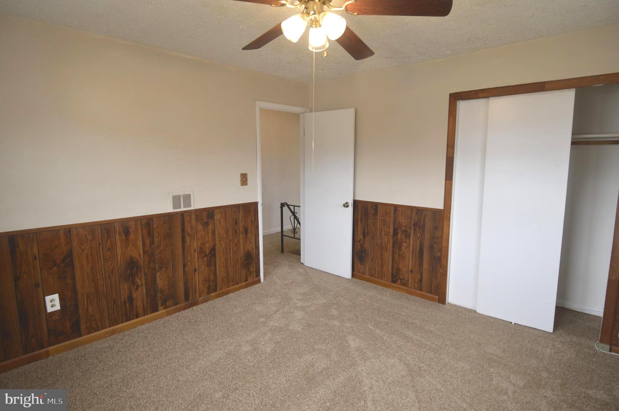 9742 Conmar Road Baltimore, MD 21220 - Photo 10 of 22 a view of an empty room with a ceiling fan