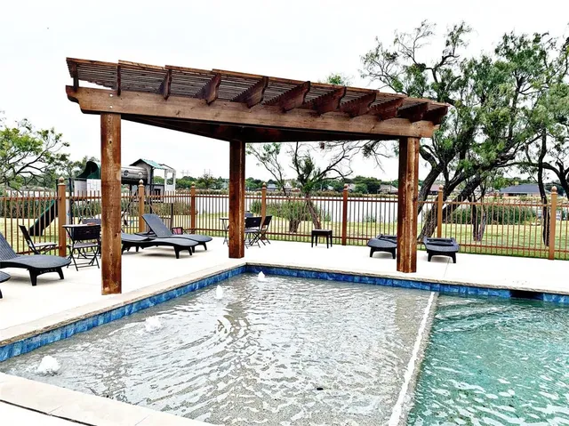 a view of a patio with a table chairs and a backyard