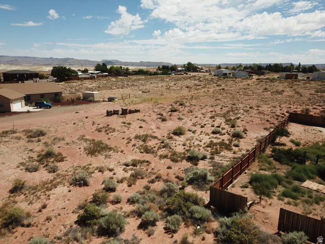 113 5th Avenue, Unit 113 Kanab, UT 84741 - Photo 11 of 13 Expansive desert landscape with natural flora, perimeter fencing, and distant mountain backdrops