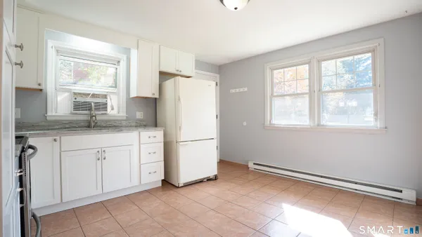 a kitchen with a refrigerator and windows