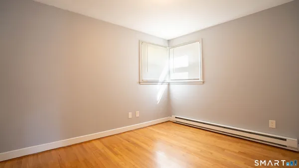 a view of a room with wooden floor and natural light