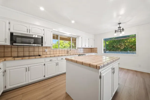 a kitchen with a sink stove and microwave