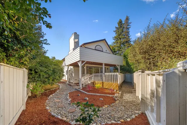 a view of a backyard with wooden fence
