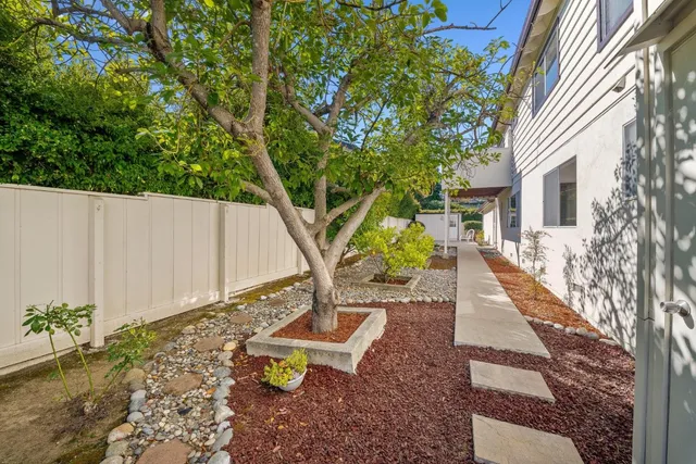 a view of a house with backyard and sitting area