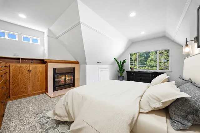 a bedroom with a bed and a potted plant