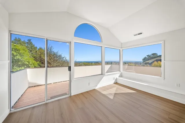 a view of a living room a wooden floor and windows