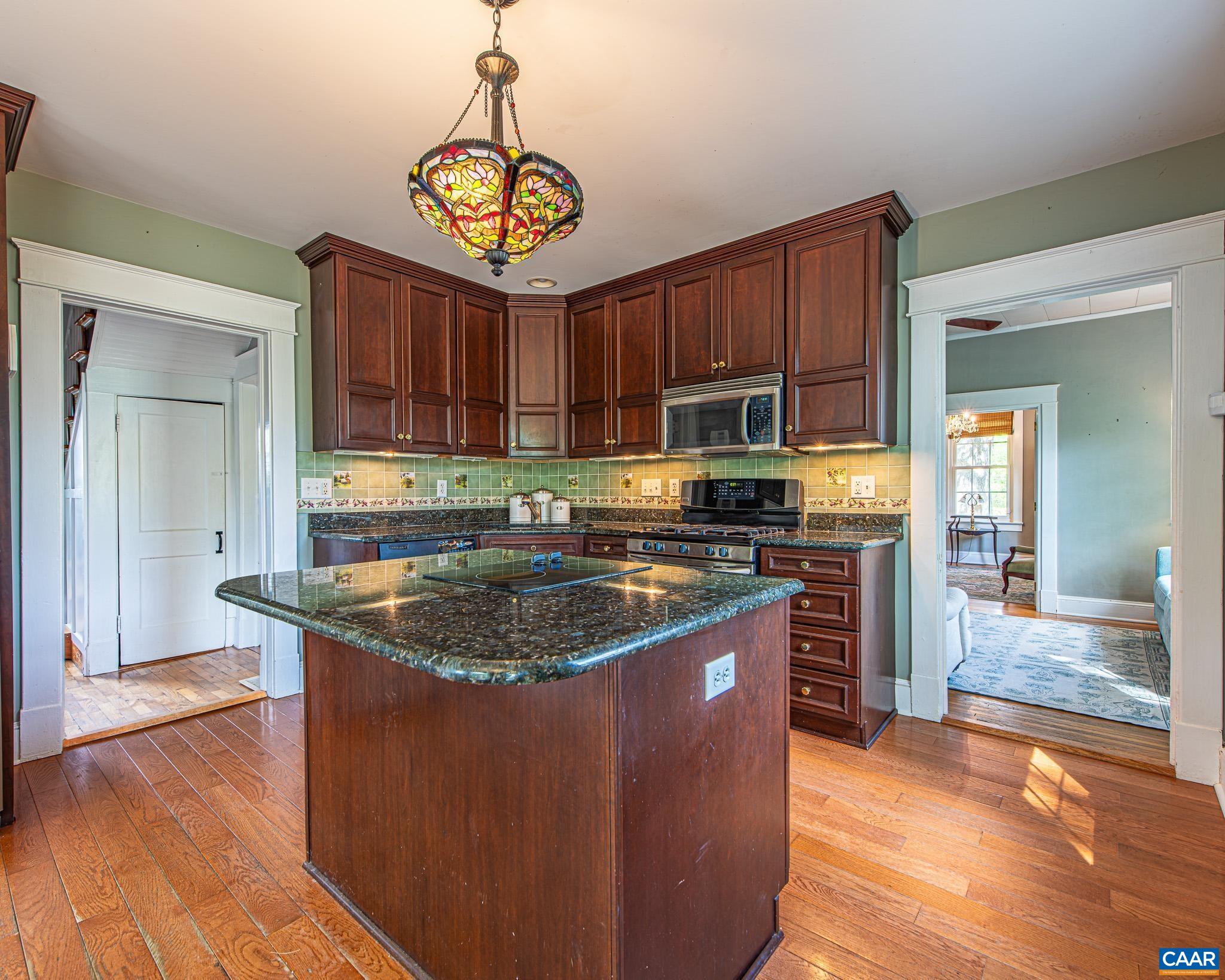 12500 Shannon Hill Road Louisa, VA 23093 - Photo 11 of 59 a kitchen with stainless steel appliances granite countertop a sink a stove and a refrigerator