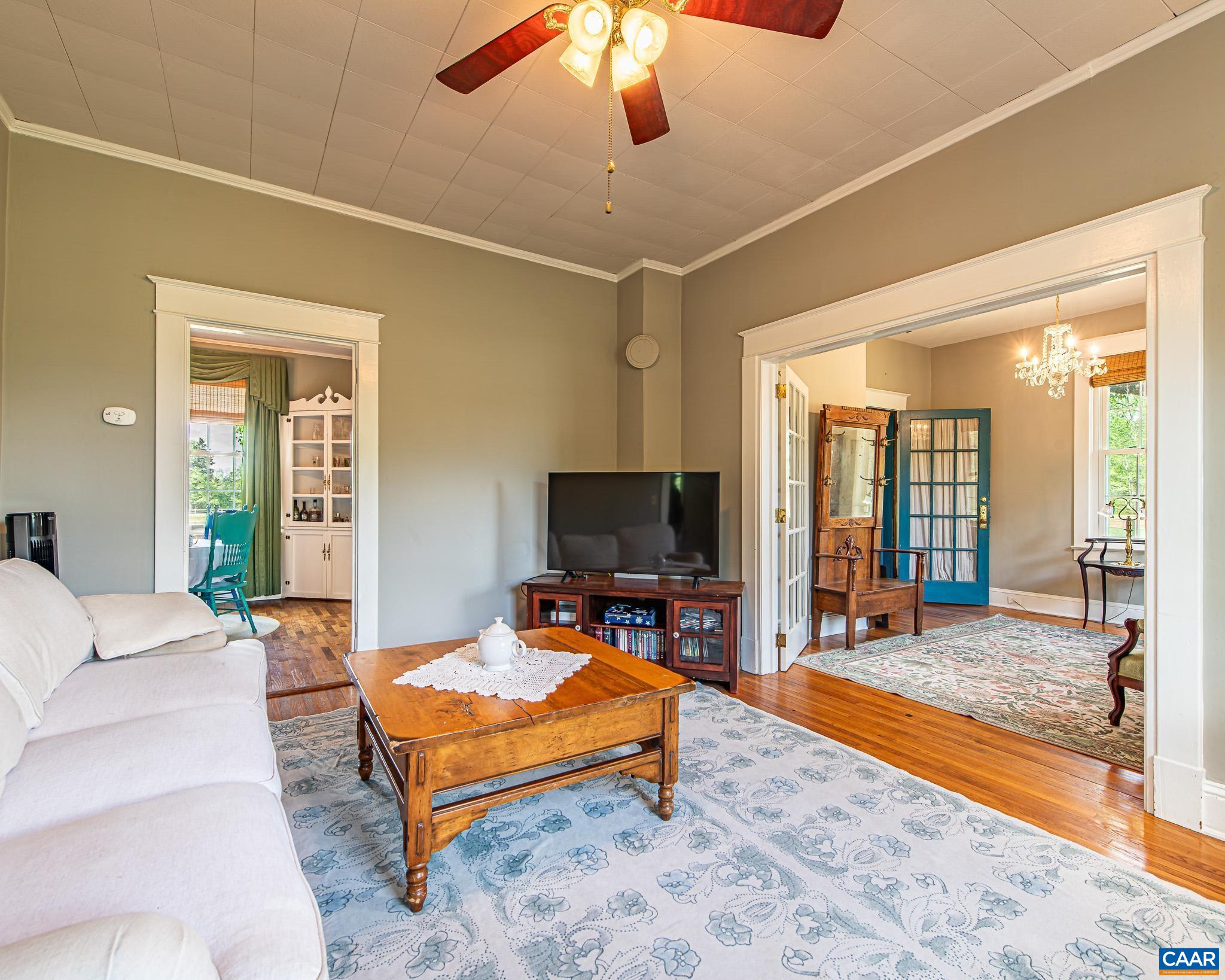 12500 Shannon Hill Road Louisa, VA 23093 - Photo 12 of 59 a living room with furniture a flat screen tv and a floor to ceiling window