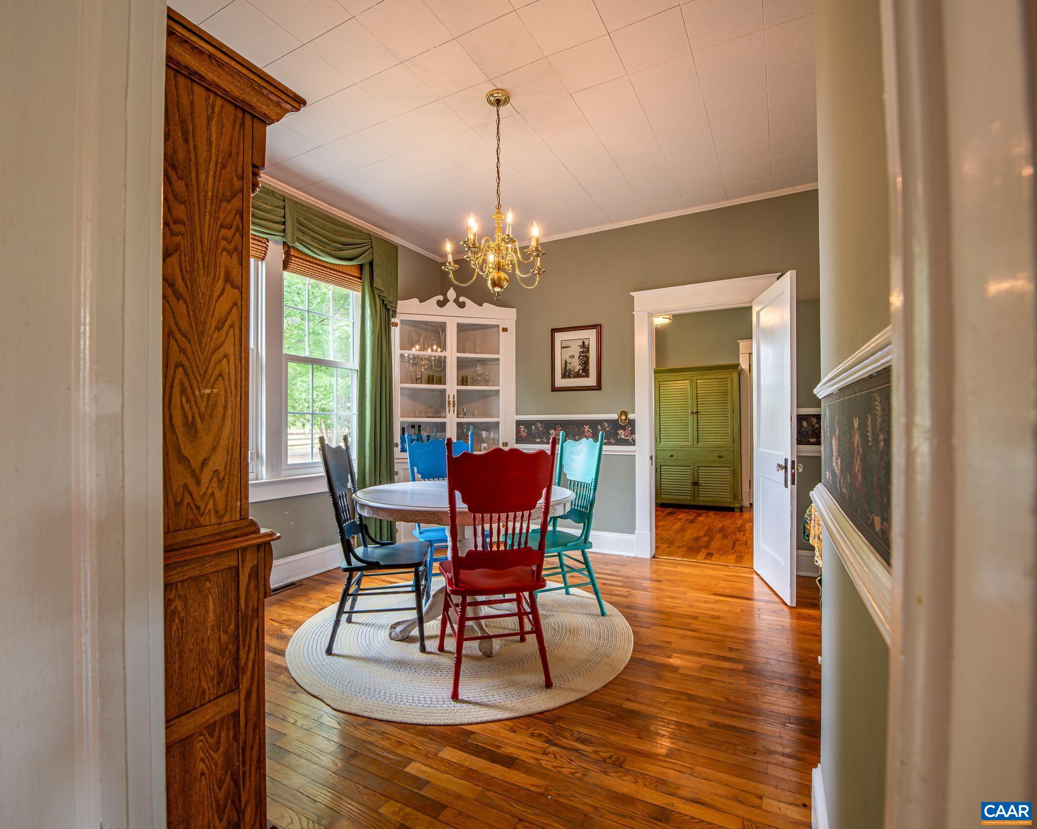 12500 Shannon Hill Road Louisa, VA 23093 - Photo 16 of 59 a dining room with furniture a chandelier and wooden floor