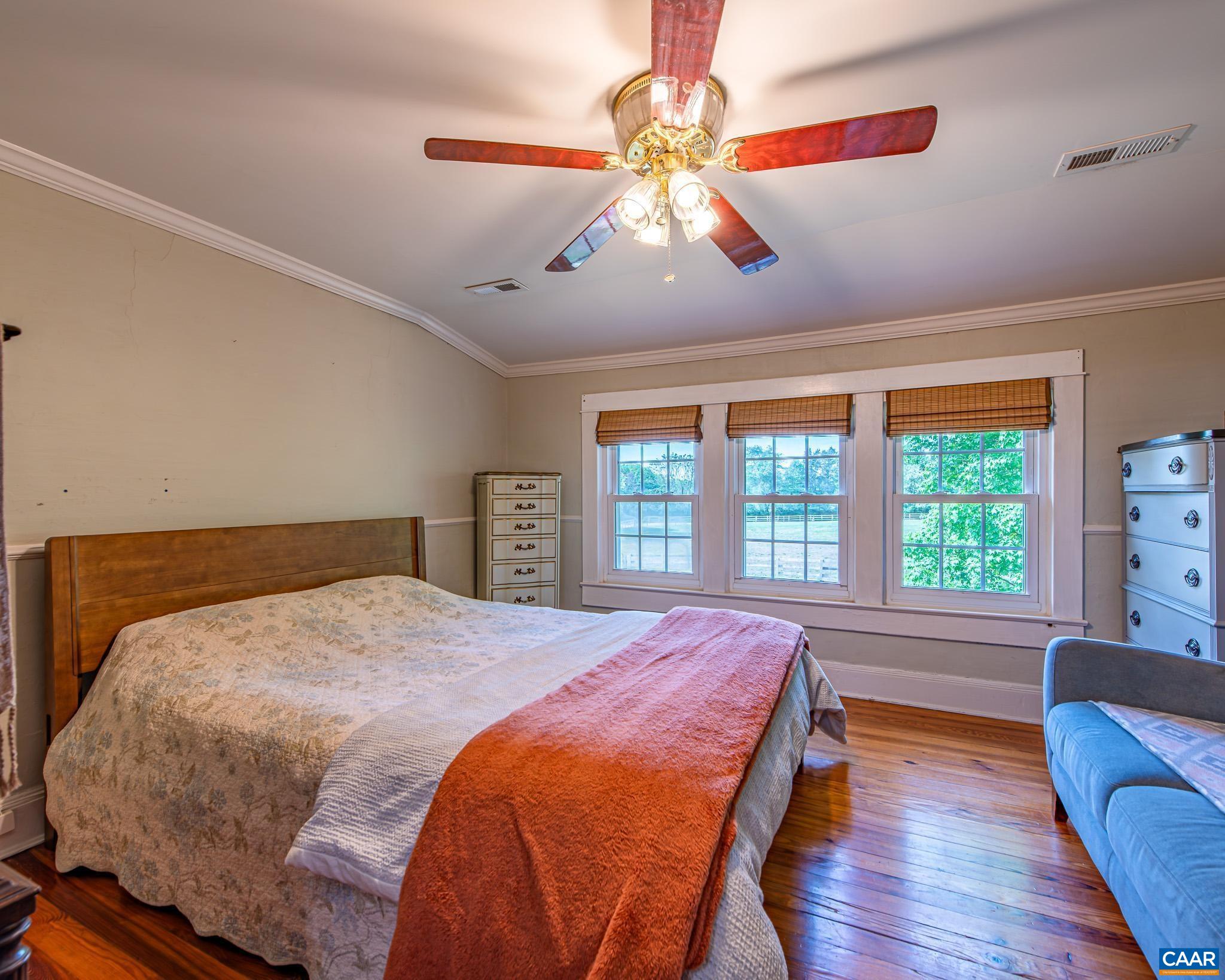 12500 Shannon Hill Road Louisa, VA 23093 - Photo 26 of 59 a bed sitting in a bedroom next to a window