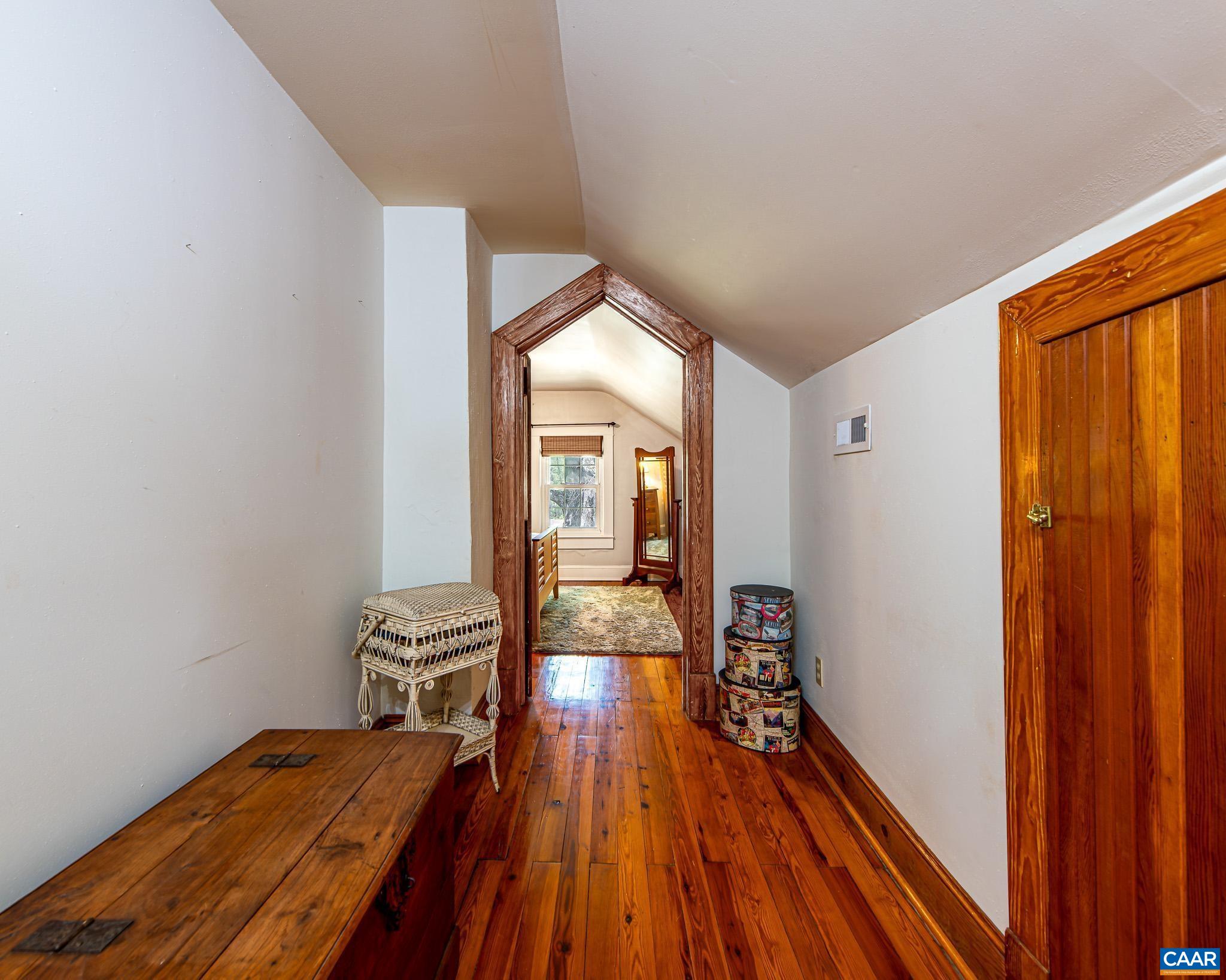 12500 Shannon Hill Road Louisa, VA 23093 - Photo 27 of 59 a view of a hallway with wooden floor and furniture
