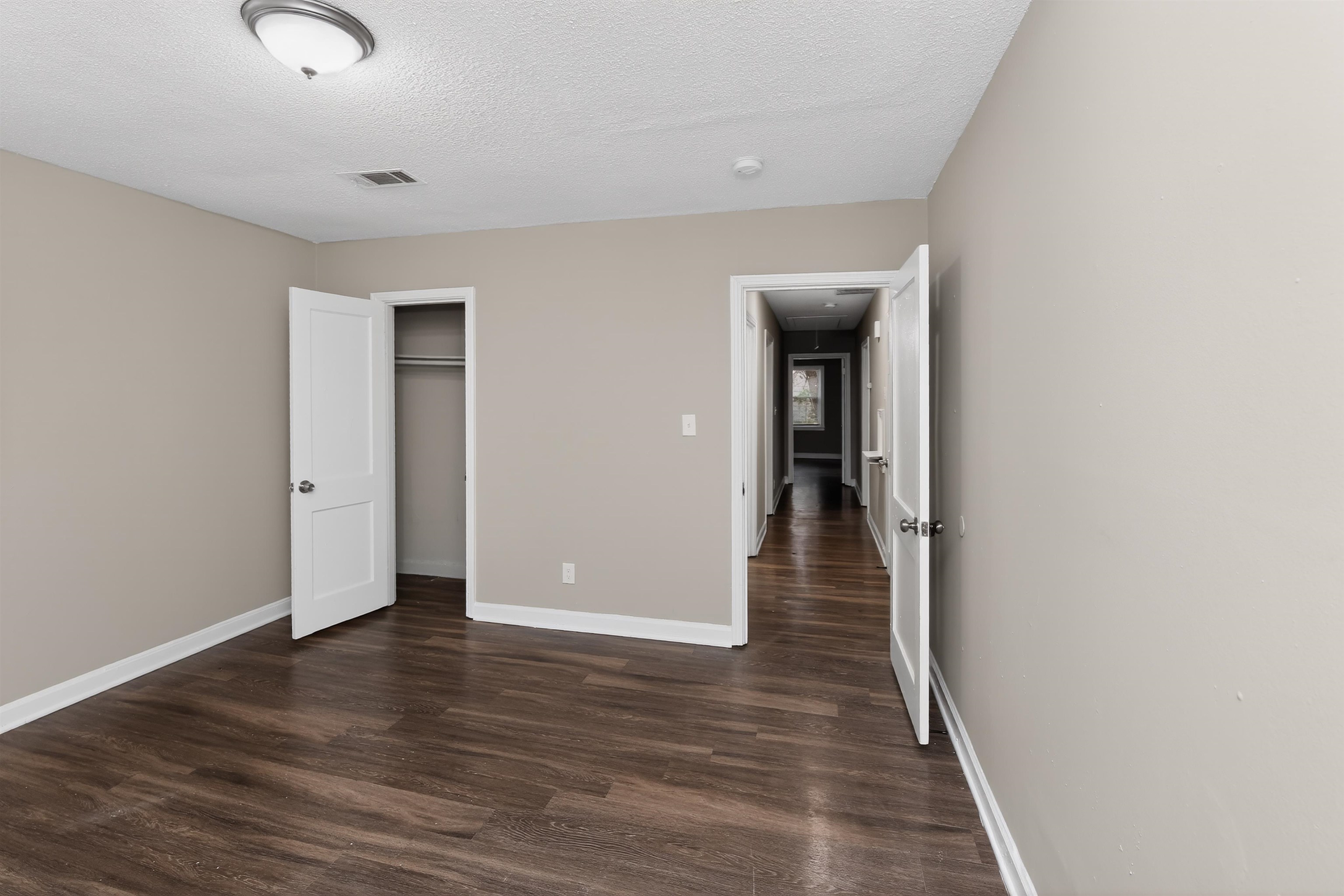 318 East Raines Road Memphis, TN 38109 - Photo 23 of 28 Neutral wall color, wood-finish flooring, white trim, and a semi-flush mount ceiling light