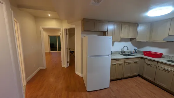 a kitchen with a refrigerator sink and cabinets