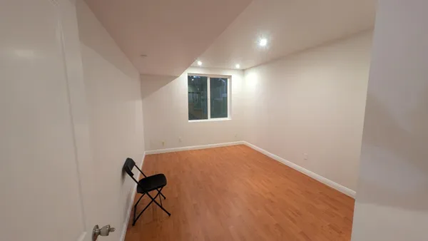 a view of room with furniture and wooden floor