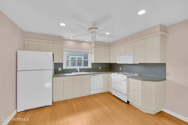 a view of a kitchen with electric appliances