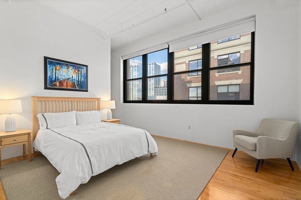 437 D Street, Unit 6A Boston, MA 02210 - Photo 14 of 26 a bedroom with a large bed and a couch