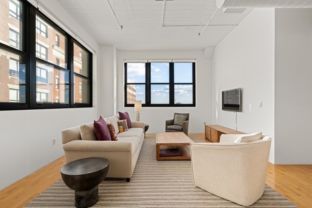 437 D Street, Unit 6A Boston, MA 02210 - Photo 2 of 26 a living room with furniture and a window