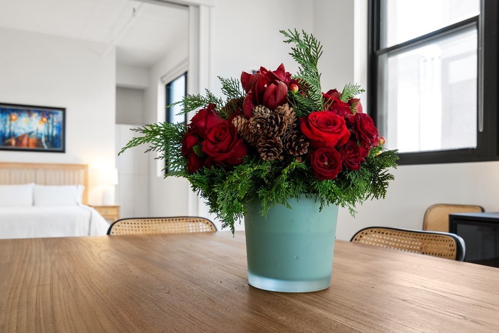 437 D Street, Unit 6A Boston, MA 02210 - Photo 8 of 26 a vase of flowers sitting on a table with a potted plant
