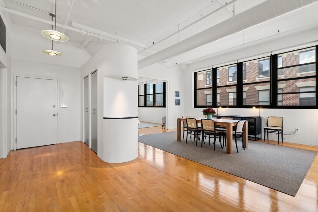 437 D Street, Unit 6A Boston, MA 02210 - Photo 9 of 26 a view of a dining room with furniture and chandelier