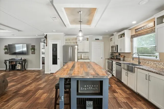 a kitchen with stainless steel appliances granite countertop a stove and cabinets