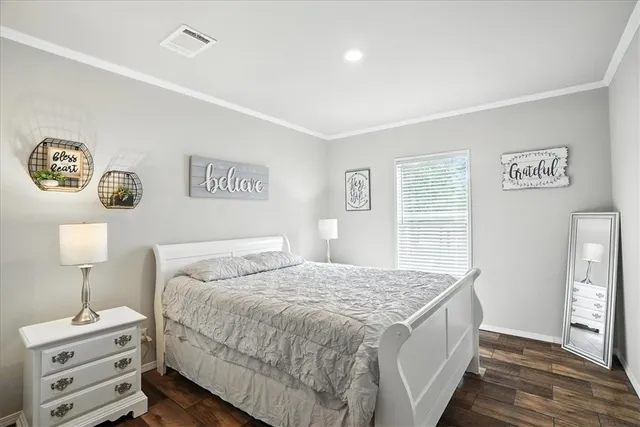 a bedroom with a large bed and a window
