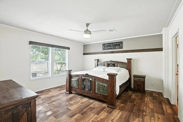 a view of bedroom with furniture and a flat screen tv