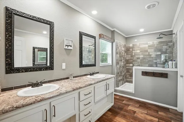 a bathroom with double sink and a mirror