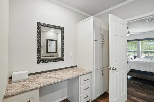 a bathroom with a granite countertop sink mirror and vanity