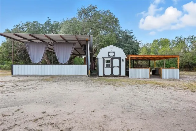 a view of a house with wooden fence