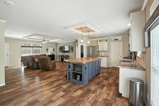 a living room with furniture a flat screen tv and a table