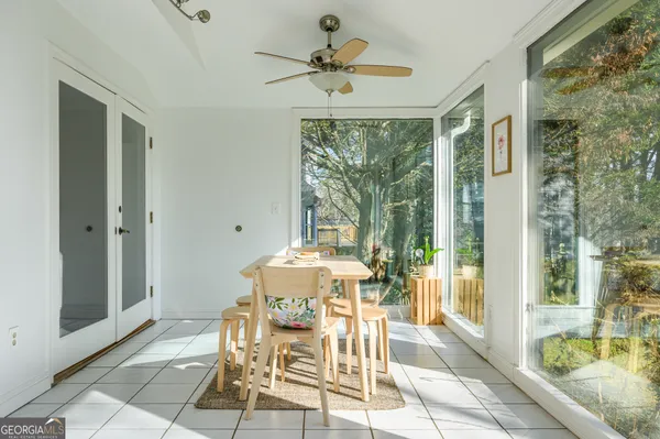 a dining room with furniture and window