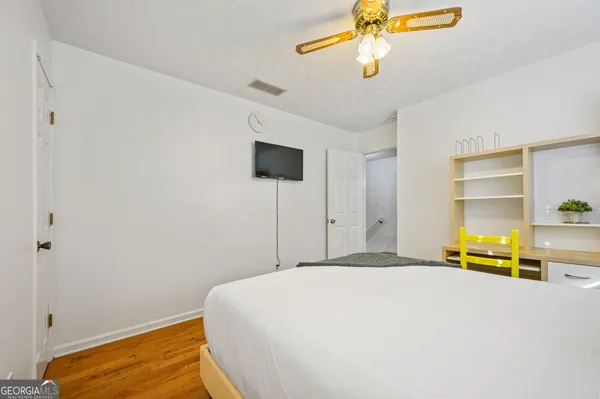 a bedroom with a bed and ceiling fan