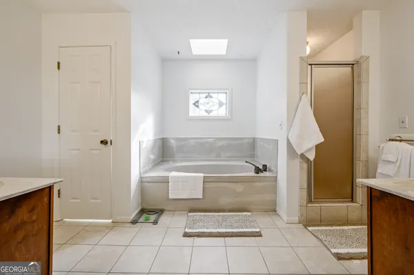 a bathroom with a bathtub and a shower