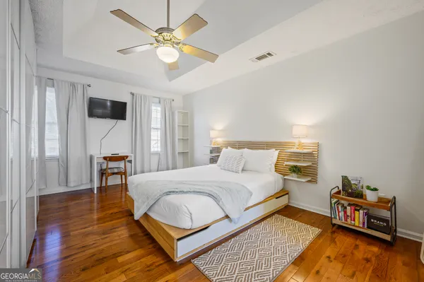 a bedroom with a bed and a chandelier