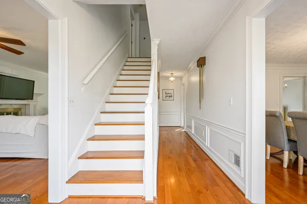 a view of entryway and hall with wooden floor