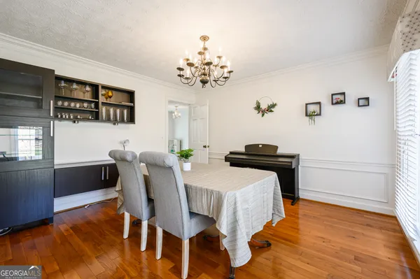 a view of a dining room with furniture and wooden floor