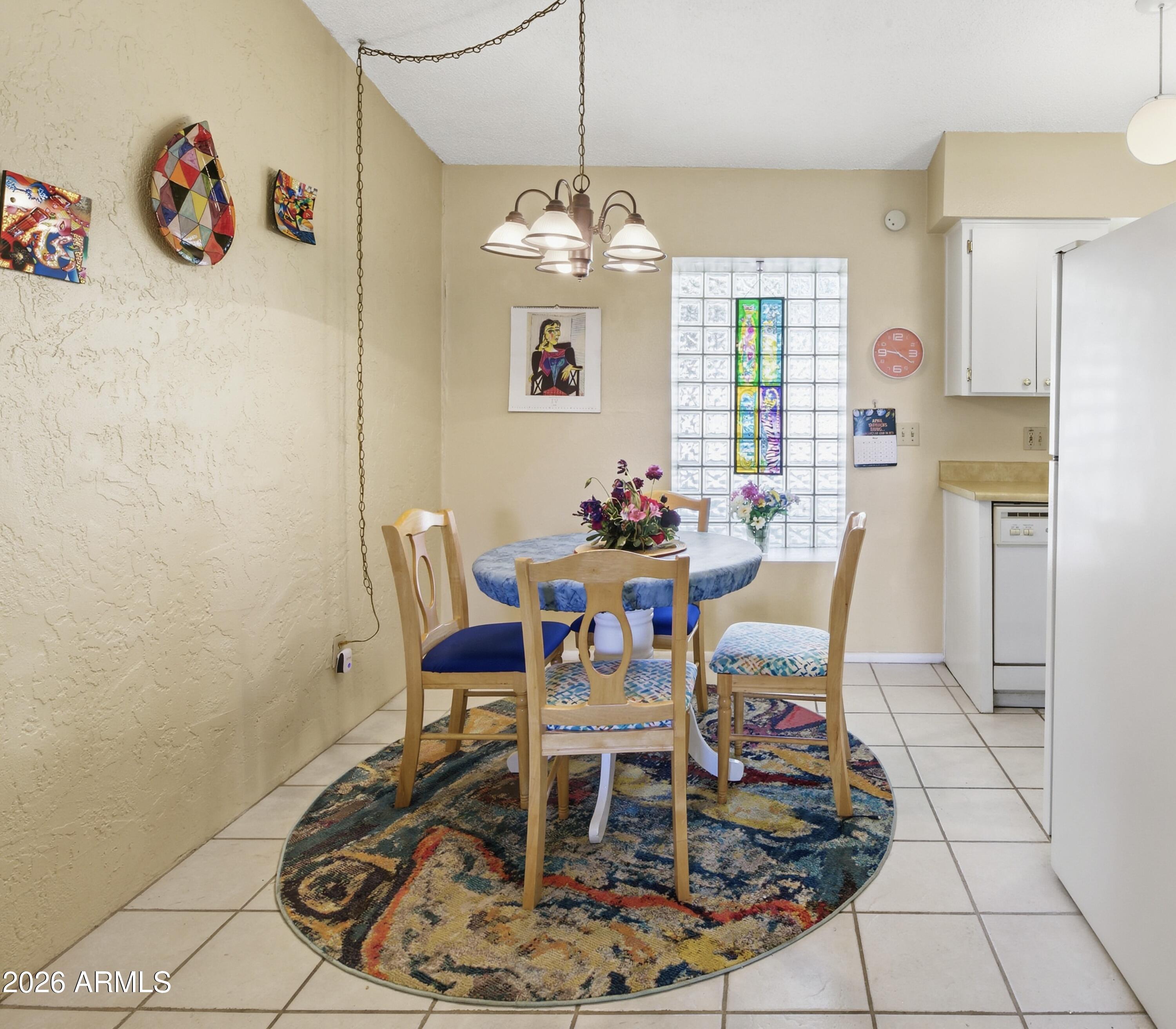 641 South Power Road, Unit 366 Mesa, AZ 85206 - Photo 11 of 22 a dining room with furniture a chandelier and window